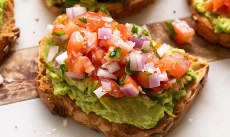 Beautifully plated avocado toast topped with radishes and microgreens