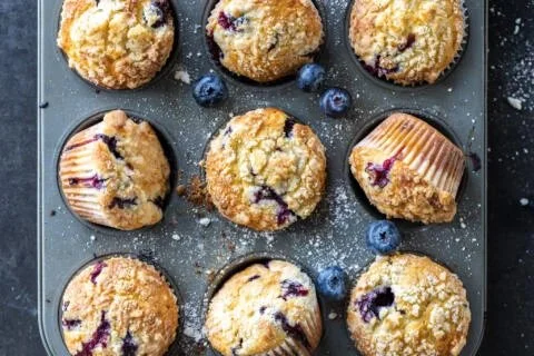 Freshly baked blueberry muffins on a cooling rack