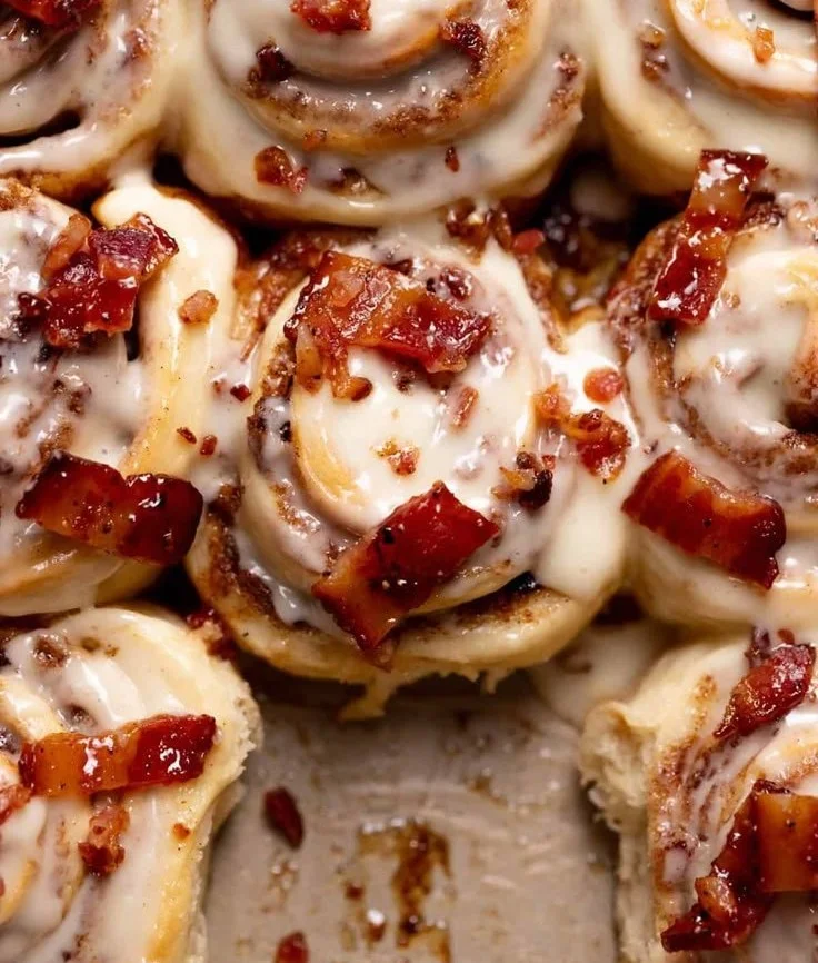 Delicious Bourbon Maple Bacon Cinnamon Rolls drizzled with caramel glaze.