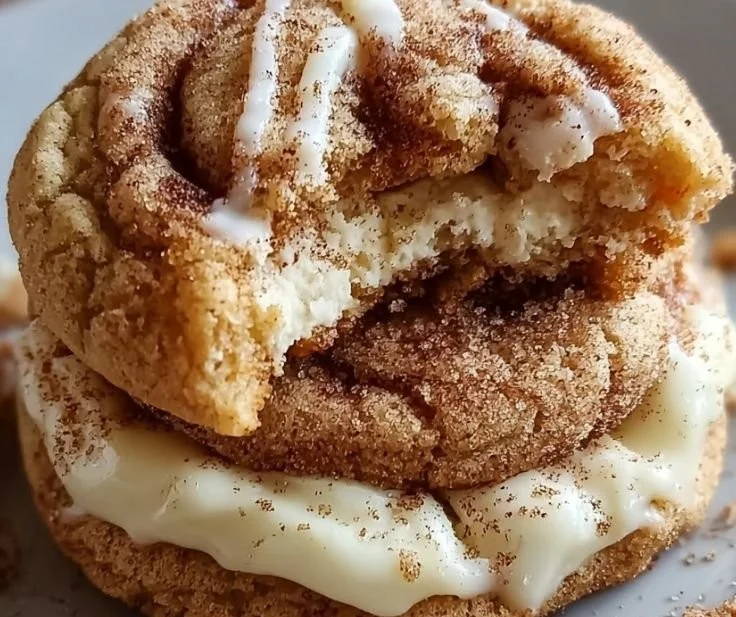 Cinnamon Roll Cheesecake Cookies served on a plate with icing.