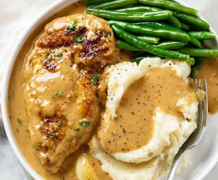 Creamy garlic chicken served with herbs and a side of vegetables