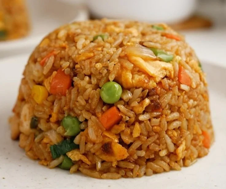 Bowl of easy chicken fried rice with vegetables and chicken pieces