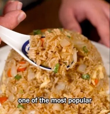 Plate of easy egg fried rice with vegetables and soy sauce