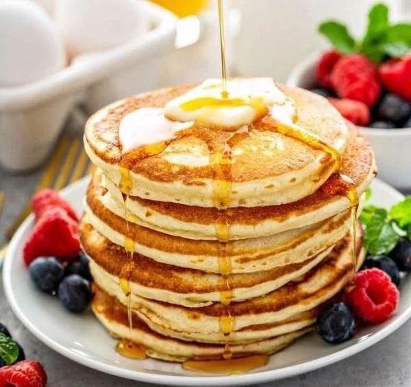 Fluffy pancakes made from an easy pancake recipe served with syrup