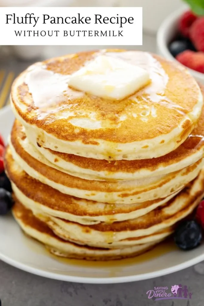 Plate of fluffy pancakes without buttermilk topped with syrup and berries