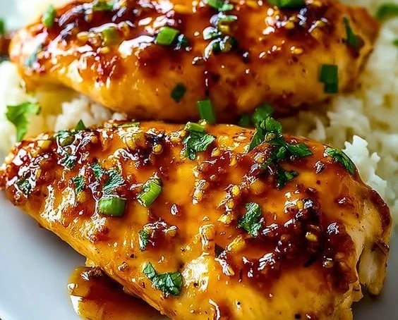 Delicious Honey Garlic Chicken Breasts on a plate garnished with herbs