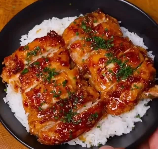 Honey Garlic Lemon Pepper Chicken Thighs plated with herbs and lemon wedges