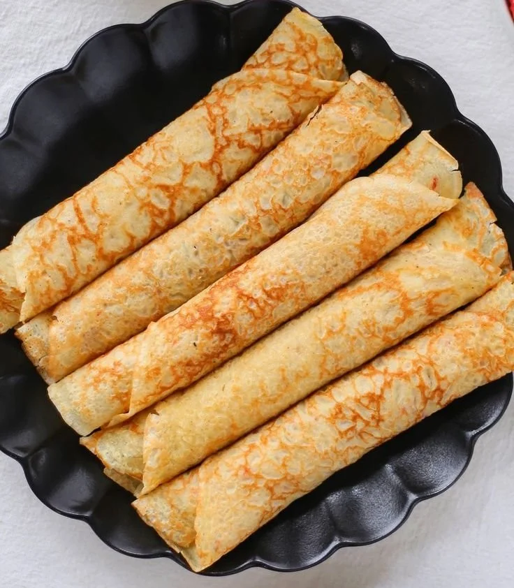 Delicious homemade crepes served with fruit and syrup