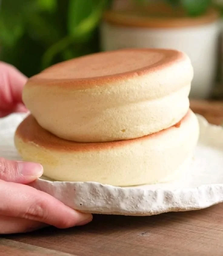 Fluffy Japanese soufflé pancakes stacked with syrup and fresh fruit