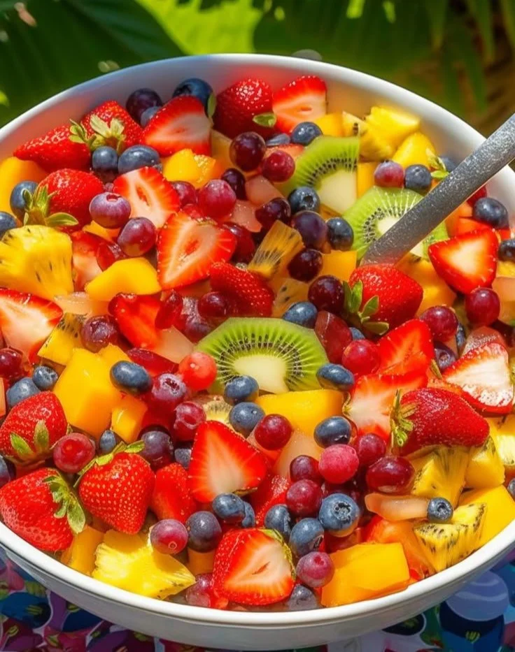 Vibrant tropical fruit salad with honey-lime dressing in a bowl