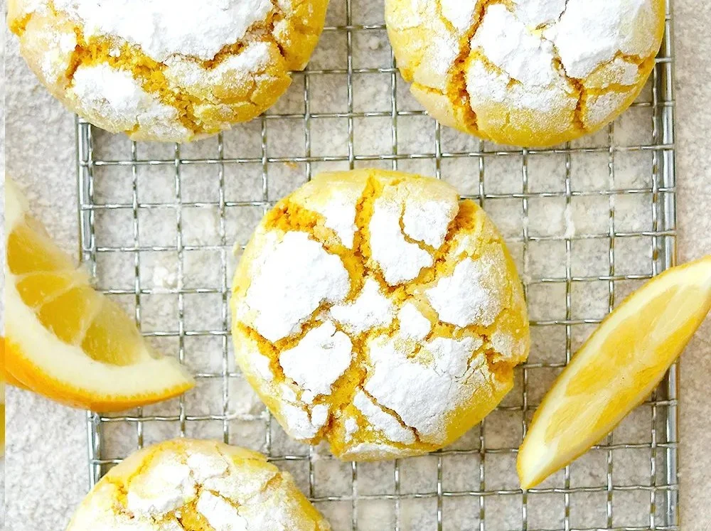 Plate of Vegan Lemon Crinkle Cookies dusted with powdered sugar
