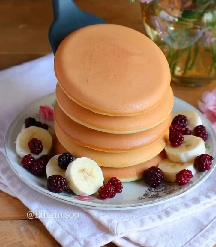 Delicious warm pancakes with a soft and fluffy texture served on a plate