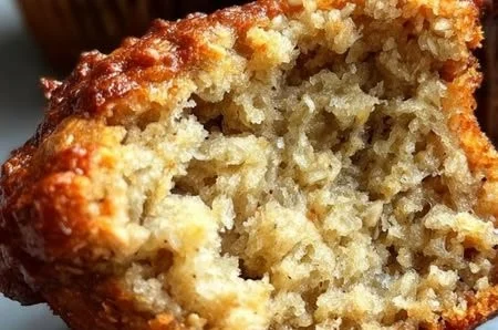 Freshly baked Banana Oat Muffins on a wooden table