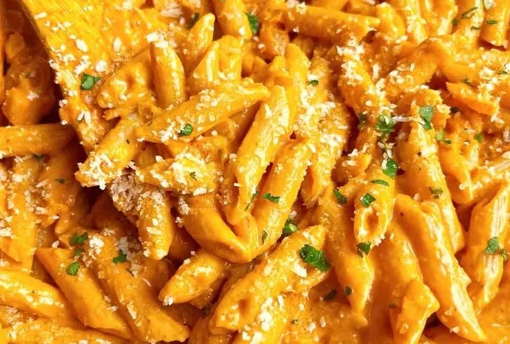 Delicious easy vodka pasta served with fresh basil and parmesan cheese