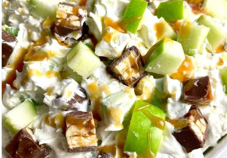 Delicious Snickers Salad featuring chocolate, caramel, and whipped cream
