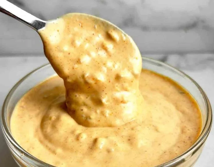 Homemade Big Mac Sauce in a bowl with burger ingredients