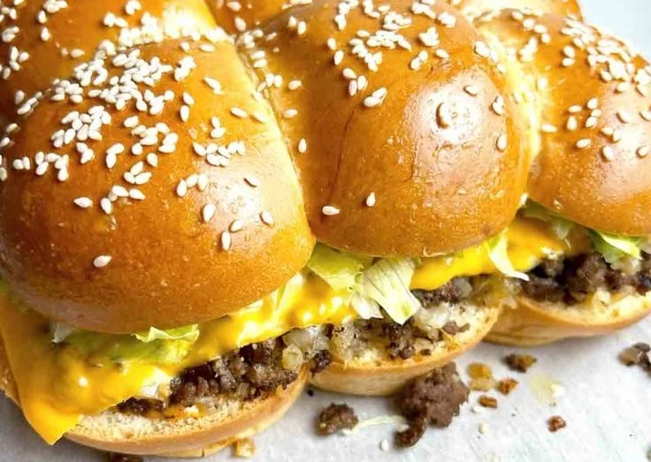 Big Mac Sliders served on a platter with toppings and sauces