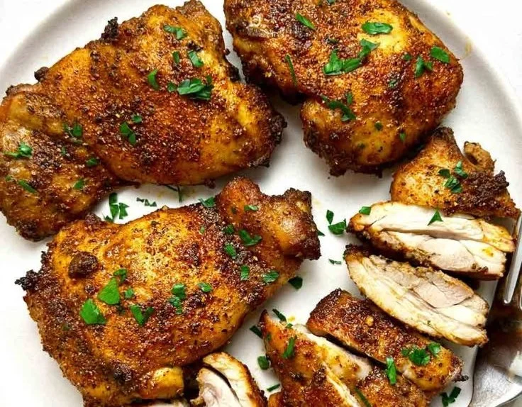 Air fried boneless chicken thighs served with vegetables on a plate