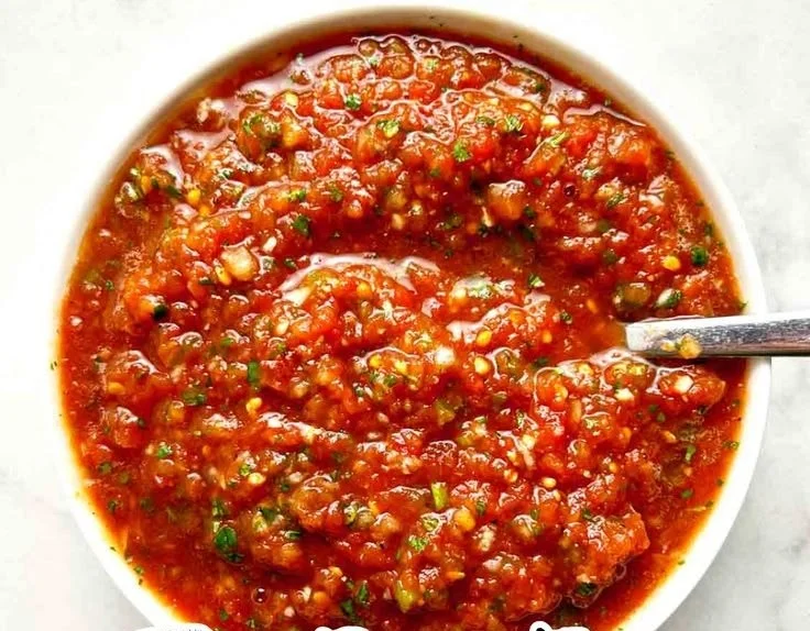 Jar of flavorful canned tomato salsa with fresh ingredients