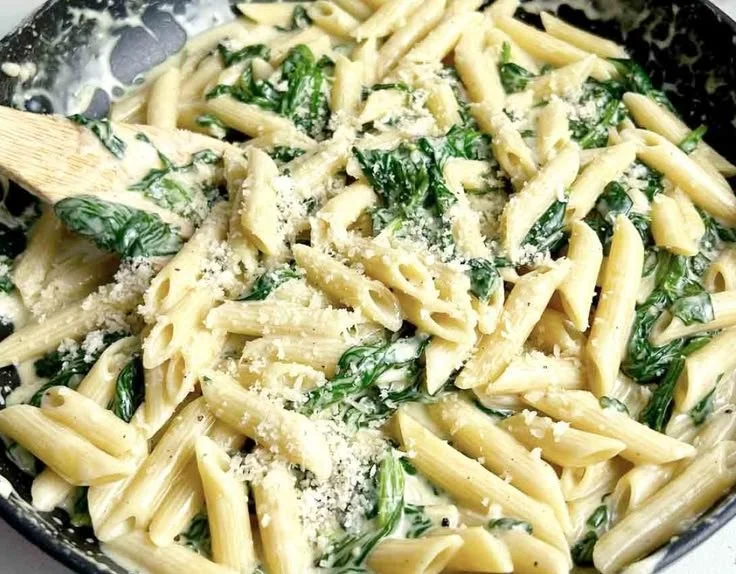 Creamy pasta dish featuring spinach and a rich sauce