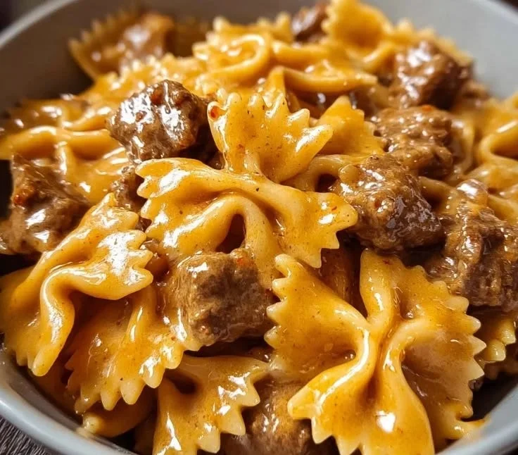 Creamy Velveeta beef and bow tie pasta dish served in a bowl