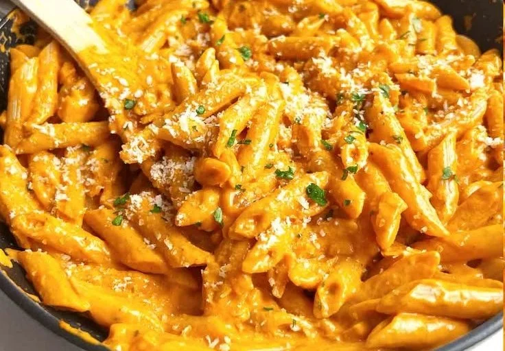 Creamy vodka pasta sauce served over fettuccine with fresh basil
