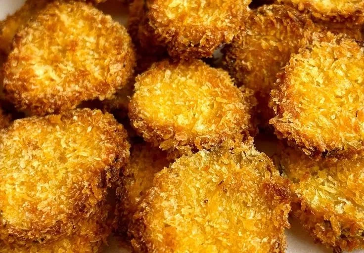 Plate of crispy air fryer pickles served with dipping sauce