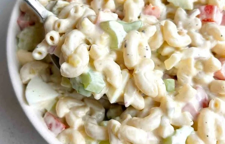 Bowl of easy macaroni salad with colorful vegetables and dressing