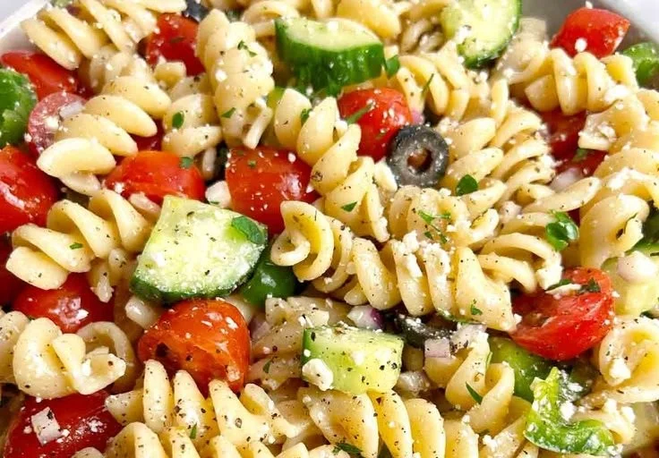 Colorful easy pasta salad with vegetables and dressing in a bowl