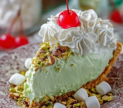 Delicious easy pistachio pie slice with whipped cream on top