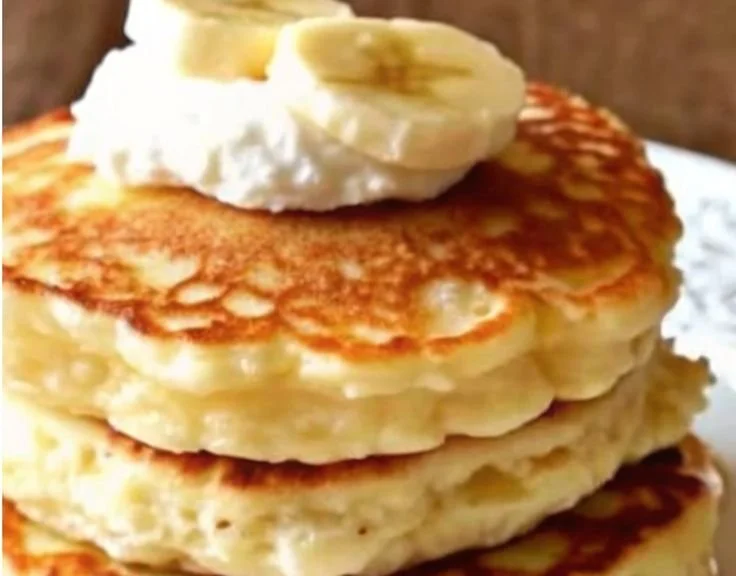 Fluffy banana pancakes with cottage cheese served on a plate