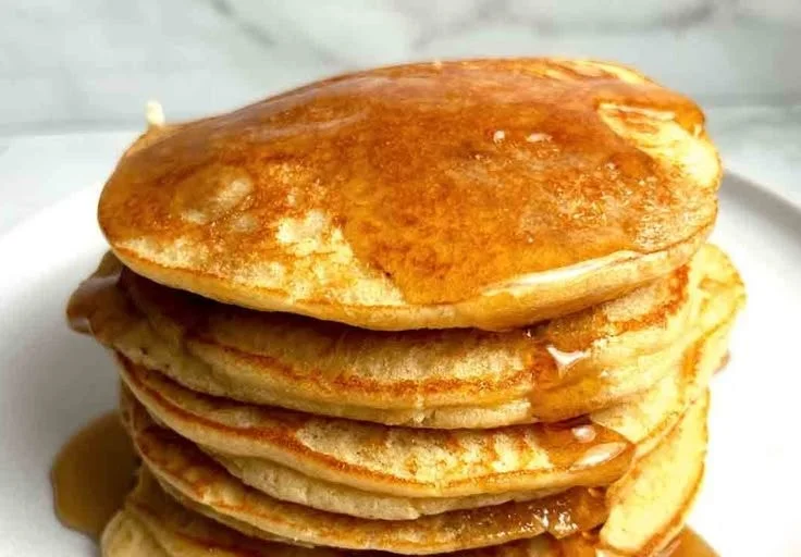 Fluffy gluten-free pancakes made with almond flour served on a plate