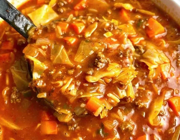 Bowl of healthy cabbage roll soup filled with cabbage, rice, and savory broth.