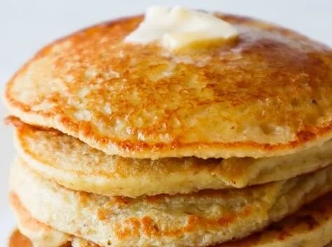 Delicious healthy oatmeal apple pancakes stacked with fresh apple slices