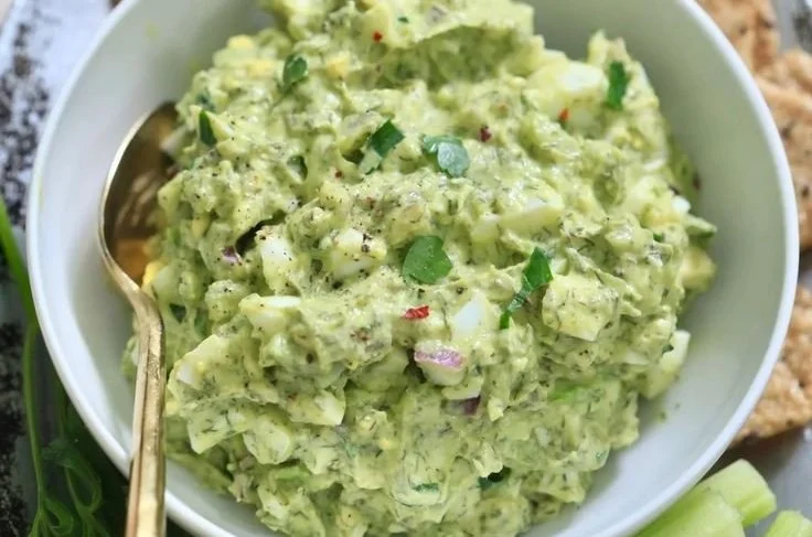 Delicious herby avocado egg salad served in a bowl for a quick lunch.