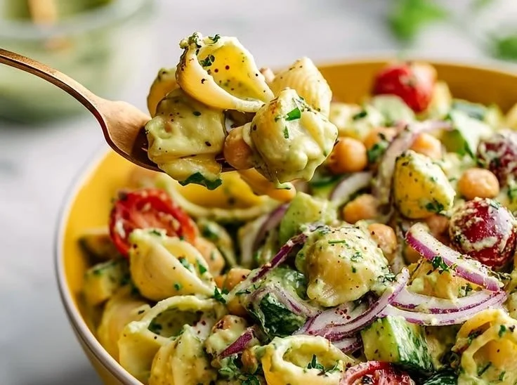 High-protein vegan avocado pasta salad served in a bowl with fresh ingredients.