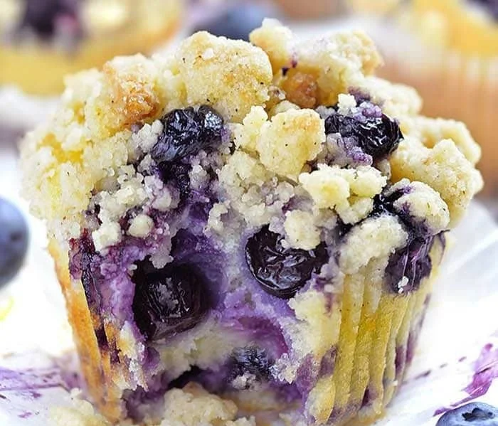Delicious homemade Lemon Blueberry Muffins on a wooden table