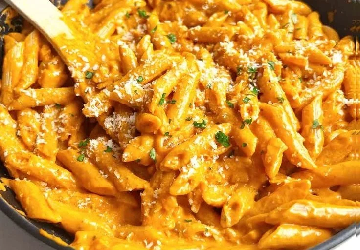 Creamy vodka pasta sauce served over spaghetti with fresh basil