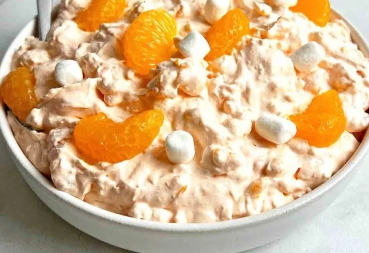 Delicious Orange Fluff Jello Salad in a bowl, topped with mandarin oranges