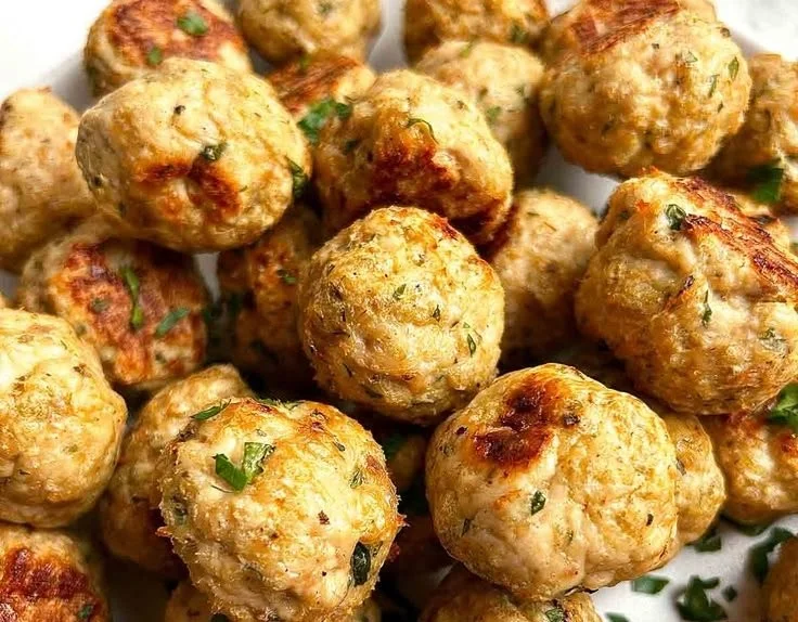 Oven-baked chicken meatballs served with pasta and sauce