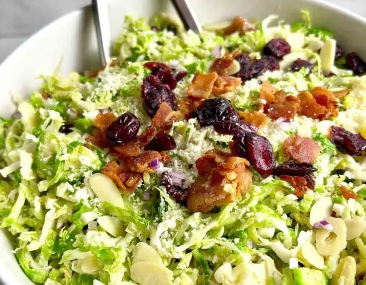 Shaved Brussels sprout salad with fresh ingredients in a bowl