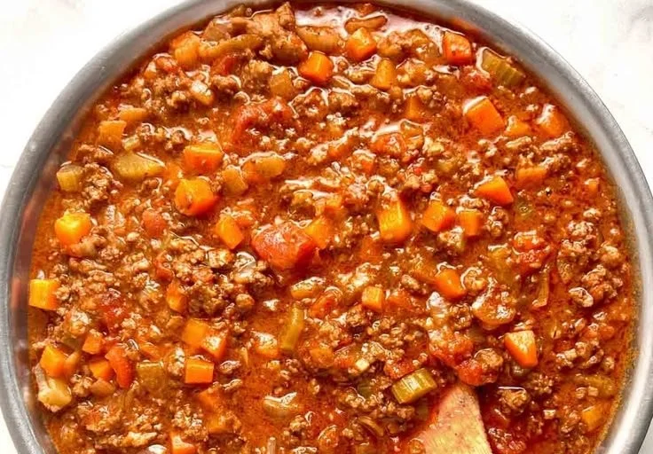 Delicious homemade Bolognese sauce simmering in a pot