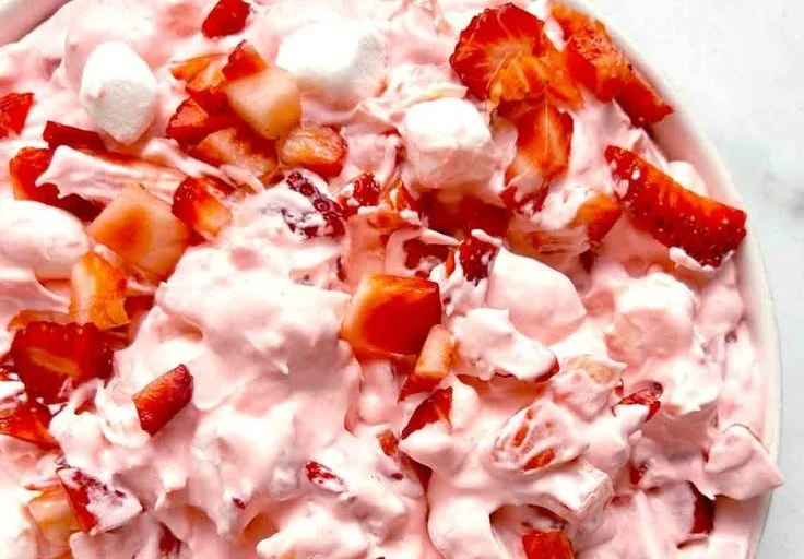 Delicious Strawberry Fluff Salad in a bowl with fresh strawberries.