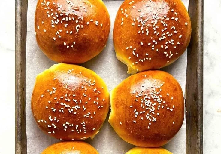Fluffy homemade burger buns freshly baked and ready for delicious burgers.