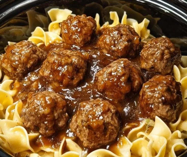 Amish meatball noodles served in a bowl with herbs and spices