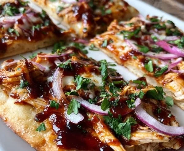 Delicious BBQ chicken flatbread topped with cheese and fresh herbs