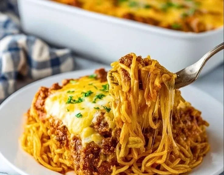 Cream cheese spaghetti casserole baked and garnished, a delicious meal for families