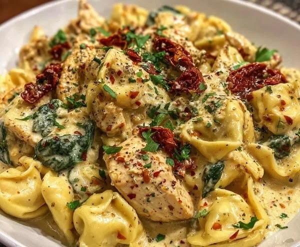 Creamy Tuscan Garlic Chicken Tortellini dish, garnished with herbs