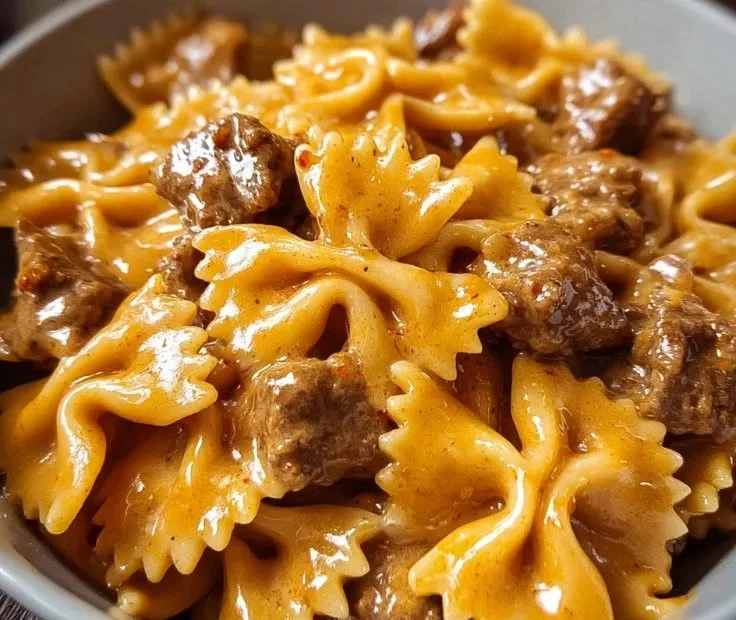 Creamy Velveeta Beef Pasta with bow tie noodles in a serving bowl