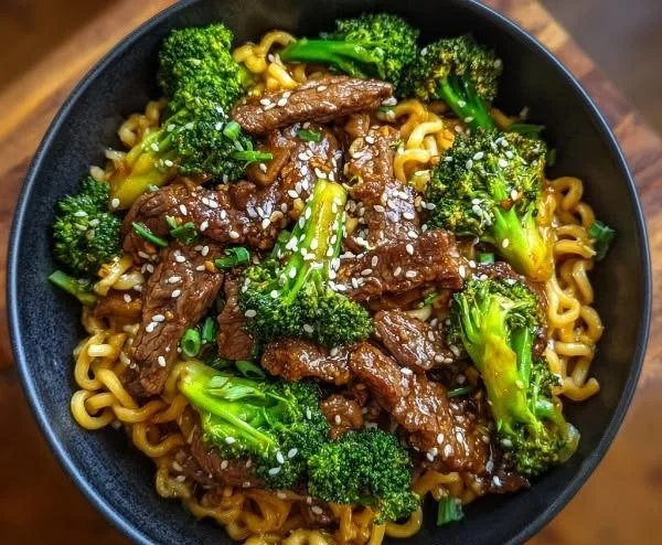 Crispy beef and broccoli noodles dish garnished with vegetables